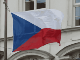 Czech national anthem — Czech flag waving in the wind, symbolizing national pride and heritage, as celebrated in the anthem of the Czech Republic.