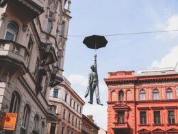 Umbrella Man Statue Prague – A captivating sculpture of a man holding an umbrella, suspended in mid-air in the streets of Prague, created by Czech artist Michal Trpák.