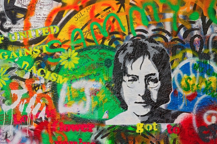 John Lennon Wall in Prague covered with colorful graffiti and peace-inspired messages.